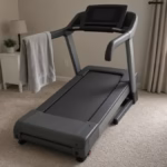 Treadmill set to a steep incline in a bright home gym for the 12-3-30 workout