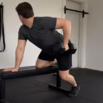 Person doing a one-arm dumbbell row on a bench in a home gym as a chin-up alternative