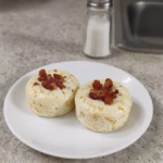 Two copycat Starbucks bacon and Gruyère egg bites on a small white plate