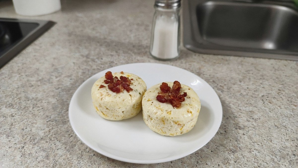 Two copycat Starbucks bacon and Gruyère egg bites on a small white plate