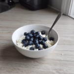 Small bowl of cottage cheese topped with blueberries