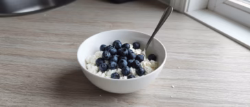 Small bowl of cottage cheese topped with blueberries
