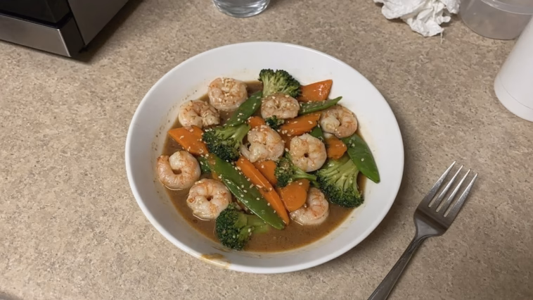 Bowl of mild shrimp stir-fry with broccoli, carrots and snow peas