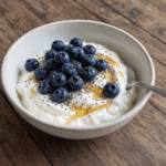 Small protein Greek yogurt bowl topped with blueberries and chia seeds