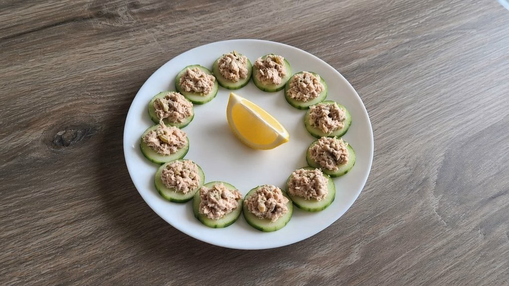 Plate of 12 tuna cucumber bites with a lemon wedge